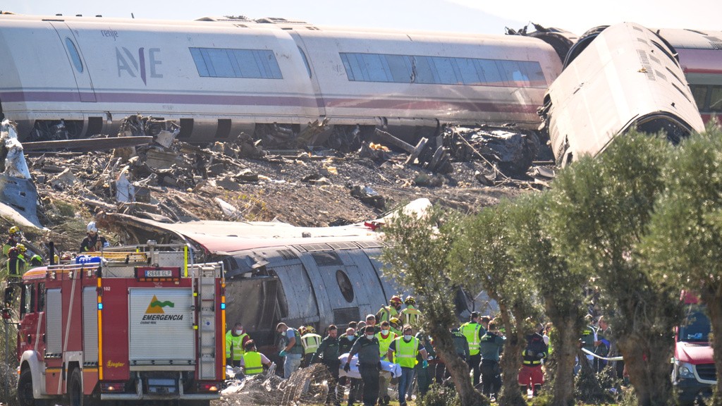 Rescue workers at the scene of a devastating train collision in Spain.